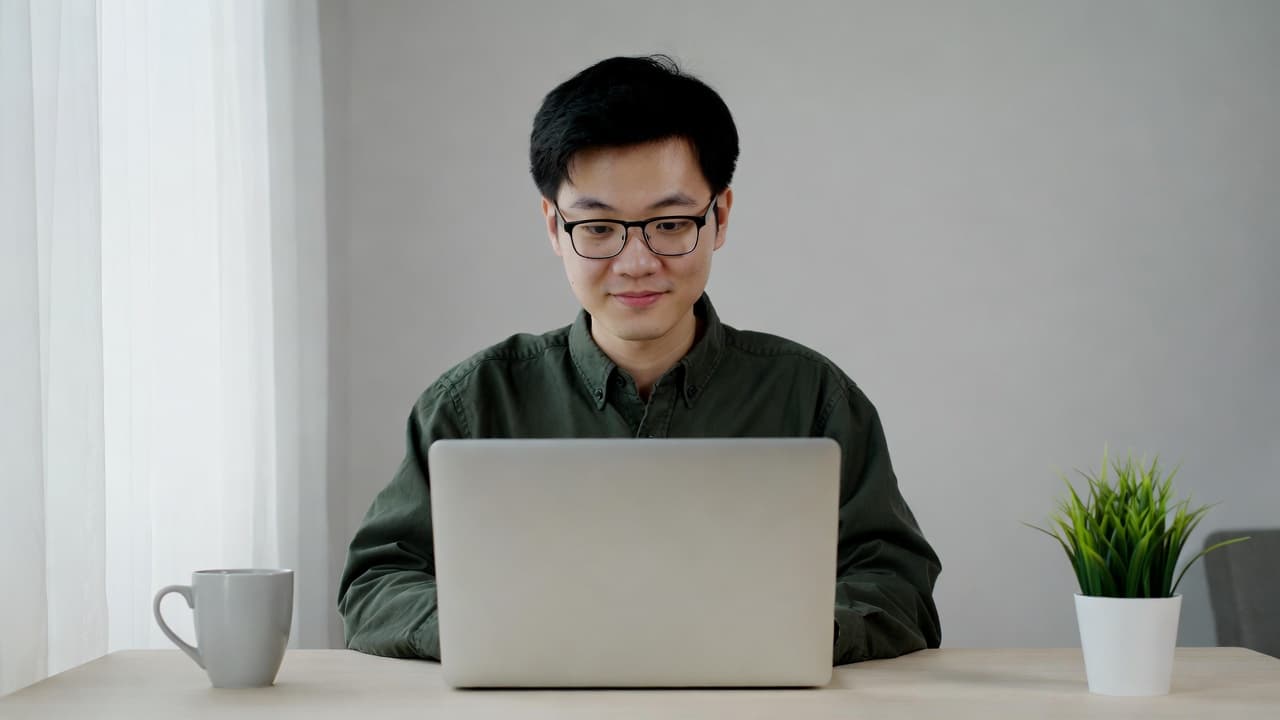 Software developer using time tracking app on laptop