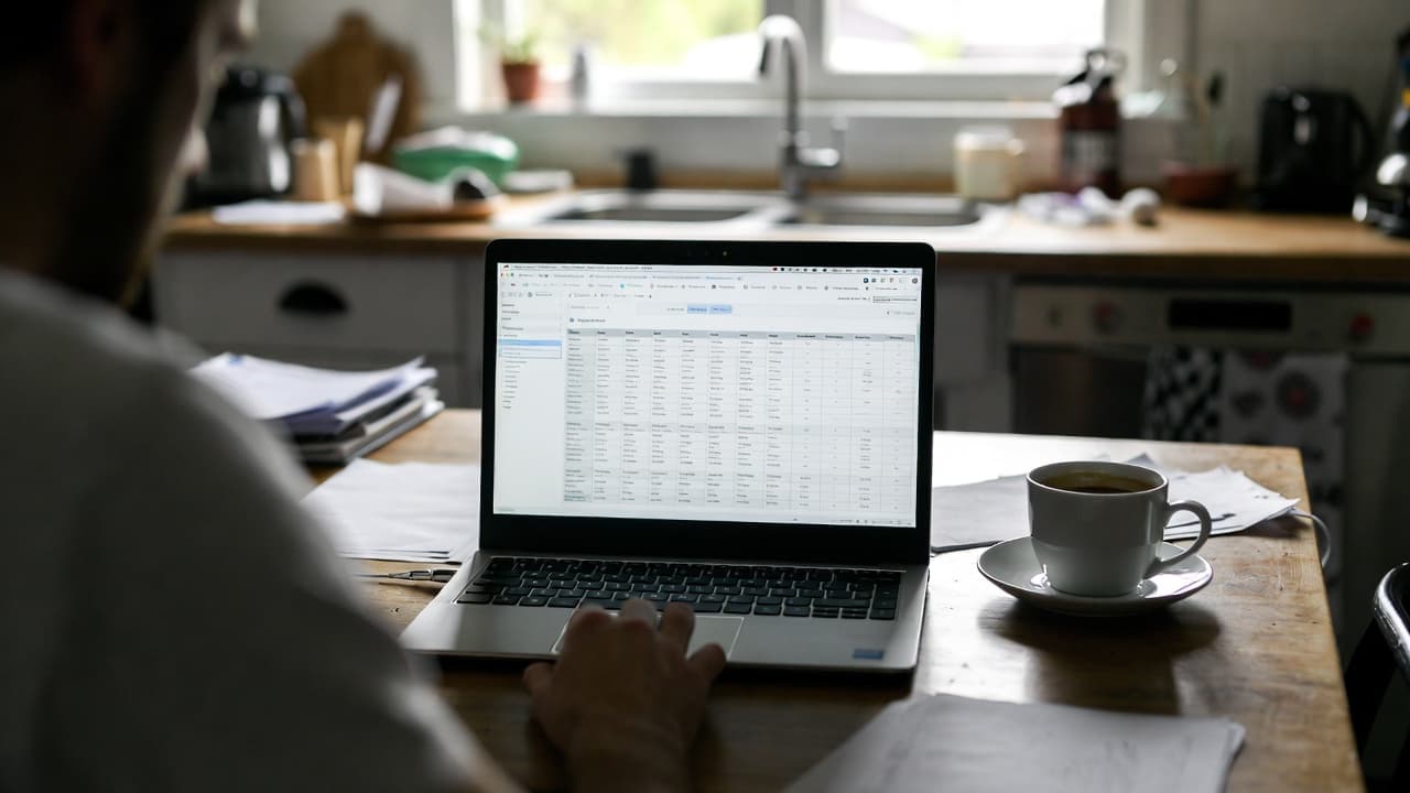 Freelancer preparing time tracking data at kitchen table